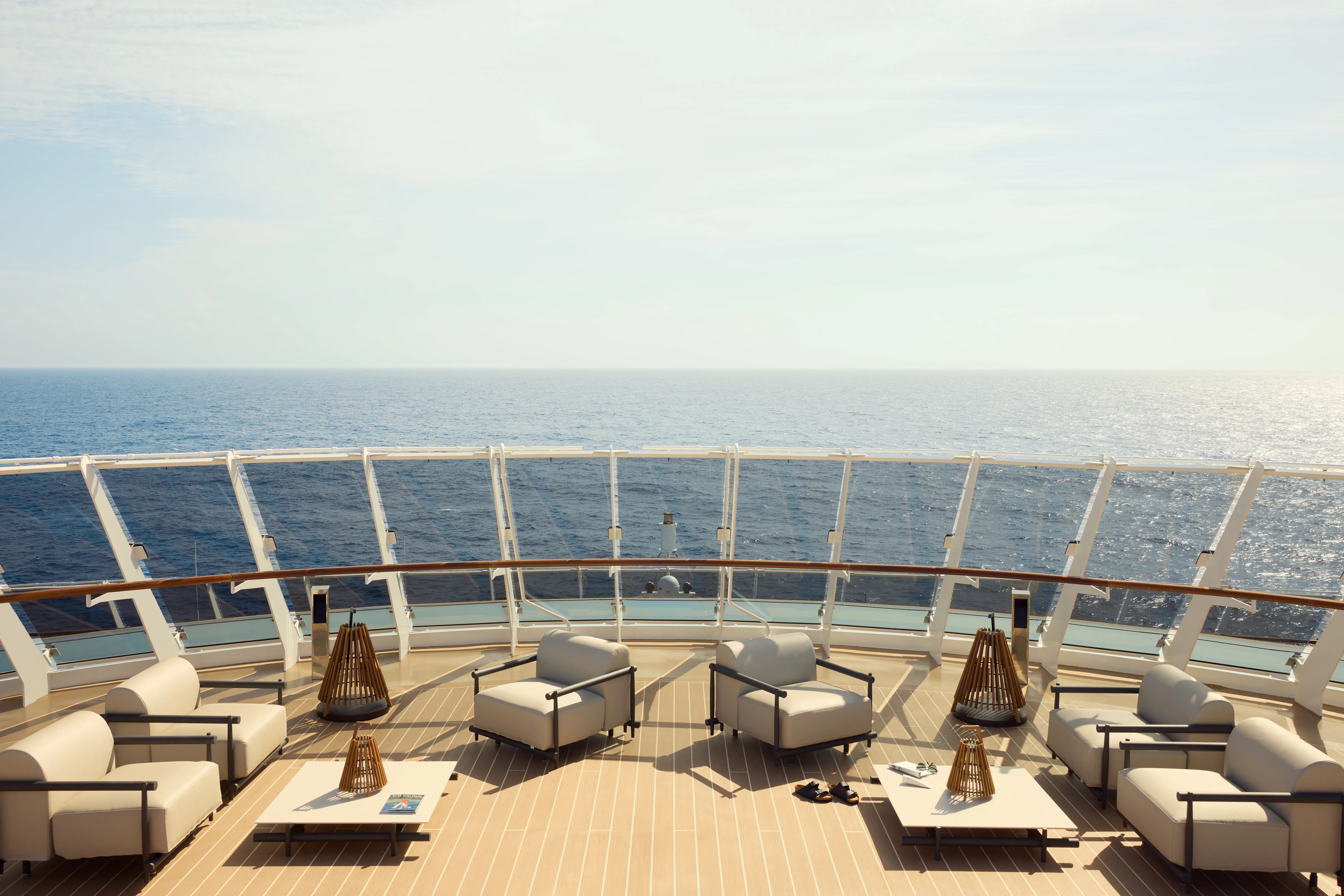 Open deck lounge area on EXPLORA I with white furniture and ocean views